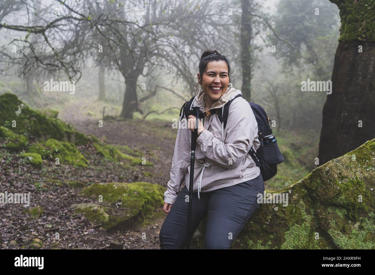 A view of the happy Caucasian female hiking in the forest Stock Photo ...