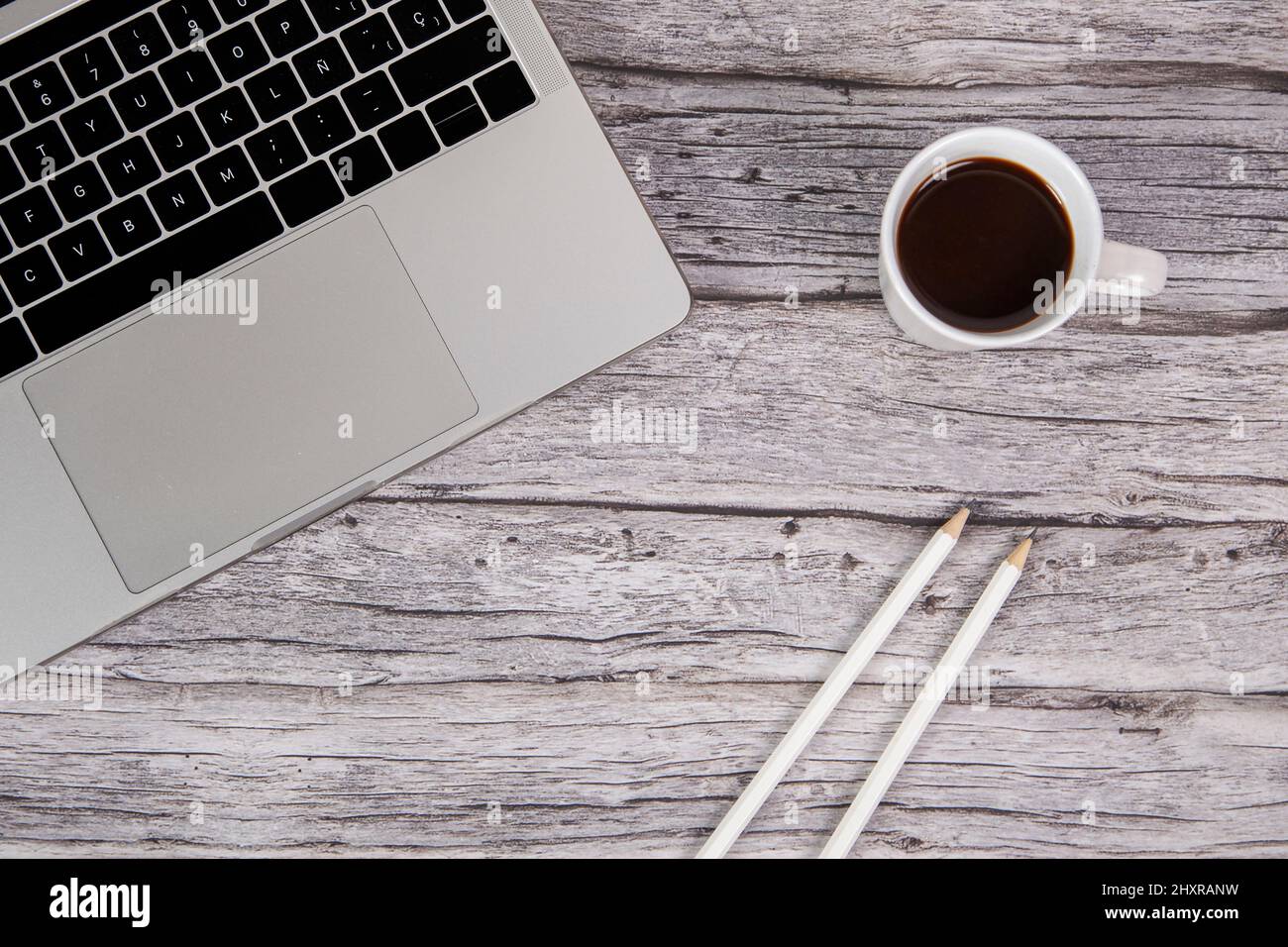 Top view of an office desk with a laptop and a cup of coffee. Stock Photo