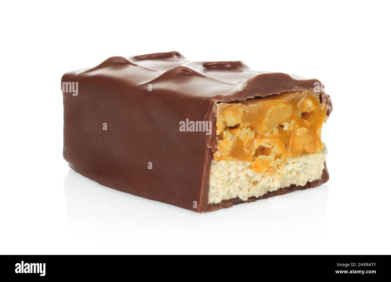 Broken chocolate bar with caramel and nuts isolated on white background