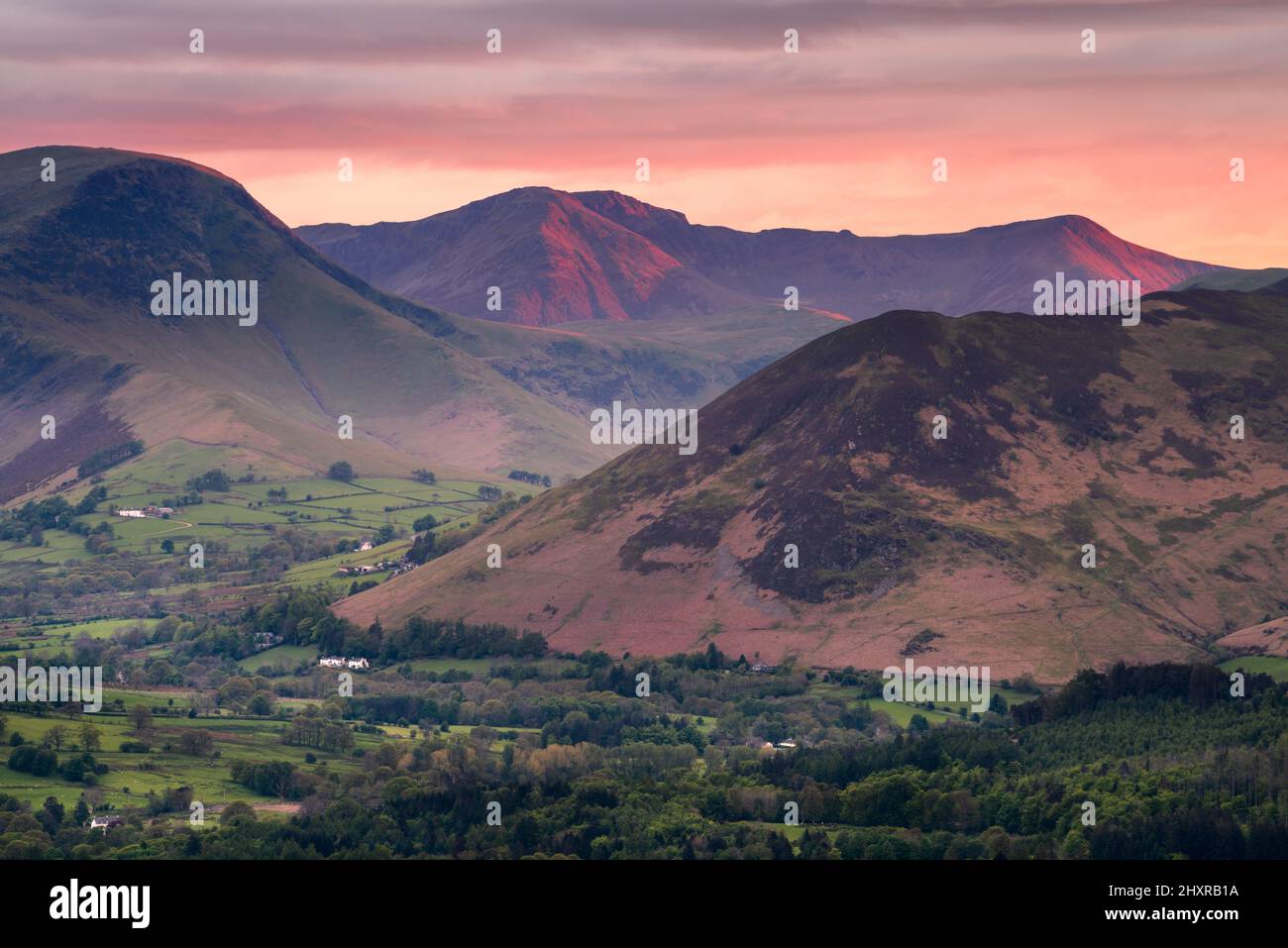 Scenic views of Lake District mountains with beautiful sunset in sky. British mountain landscape with dramatic evening light. Keswick, Lakeland, UK. Stock Photo