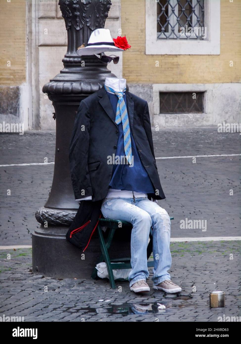 View of a street performer with no head sitting on the chair Stock Photo Alamy