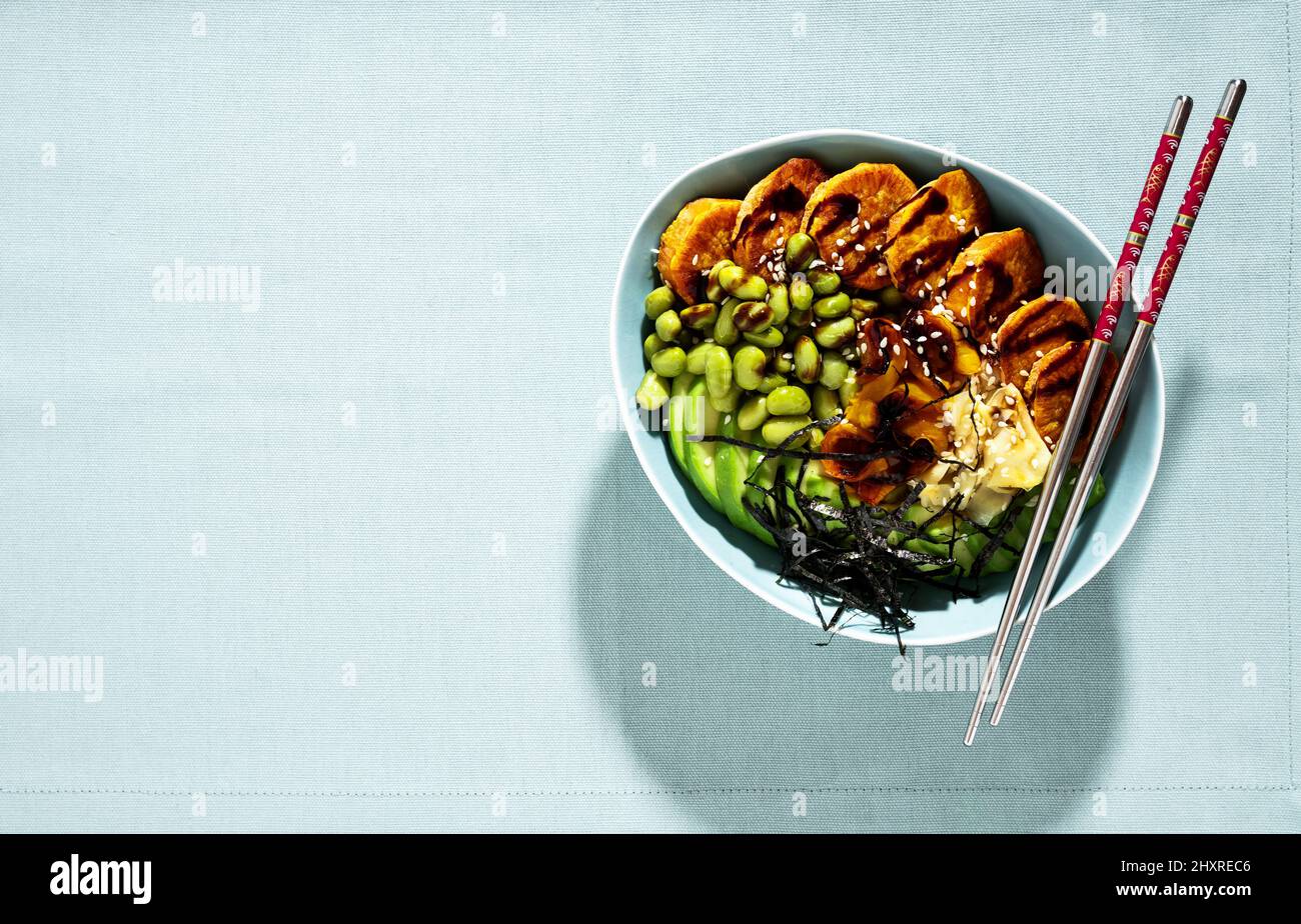 vegan sushi bowl with baked sweet potato, edamame beans, avocado and