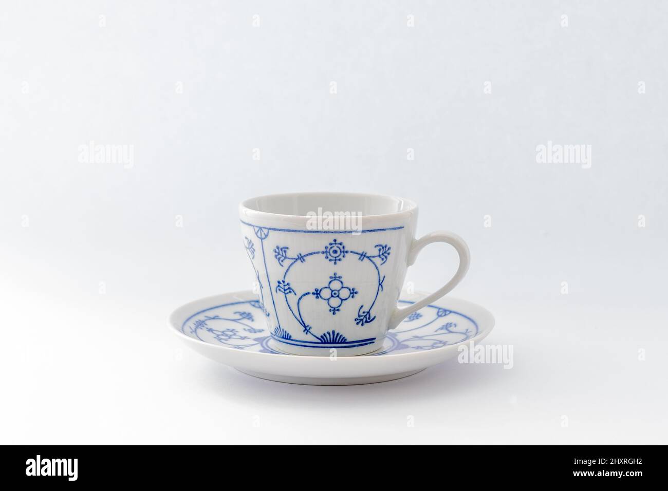 Blue white china teacup and saucer on a white background Stock Photo