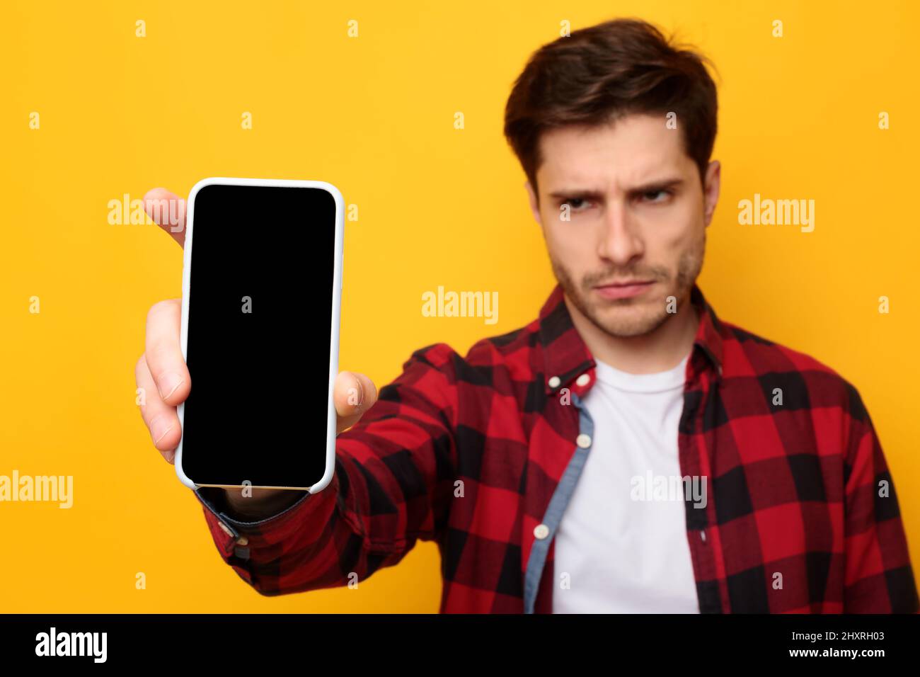 Sad guy holding showing empty smartphone screen Stock Photo