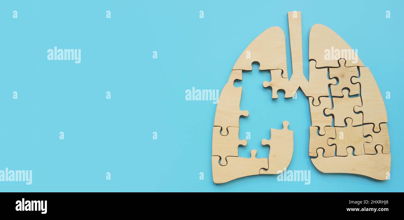 Lung from puzzle pieces with a hole symbolizing the disease. Stock Photo