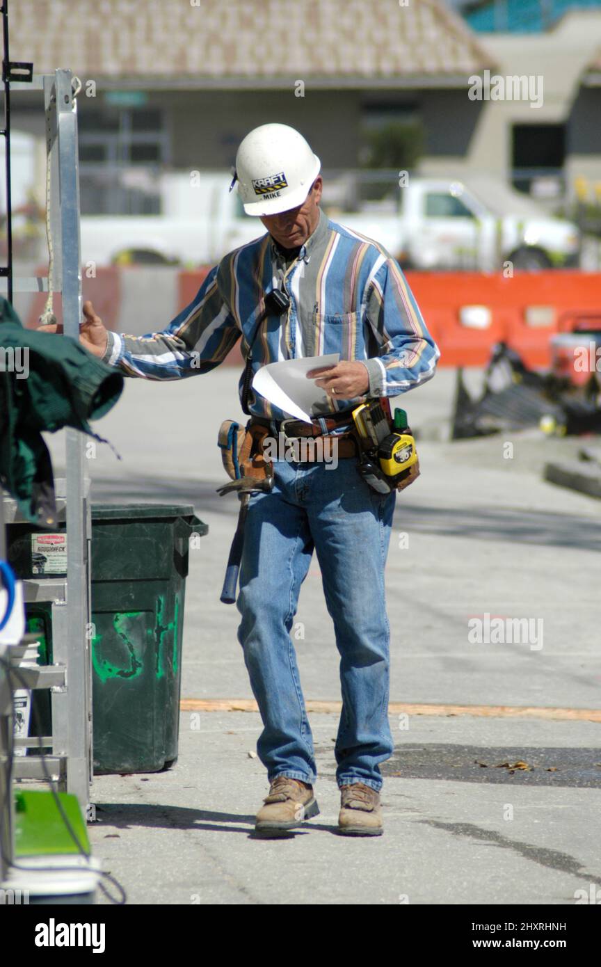 Major construction site in downtown Sarasota Florida Steelworker with plans Stock Photo Alamy