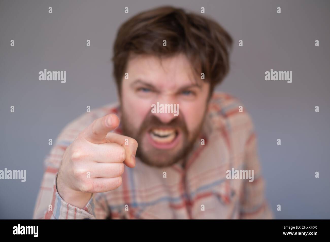 Young handsome man with beard pointing displeased and frustrated to the camera, angry and furious with you Stock Photo