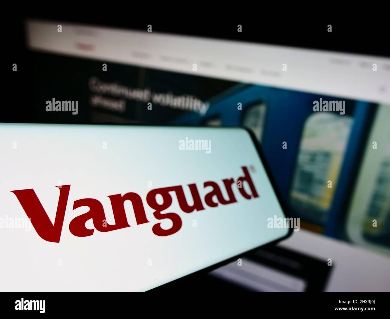 Smartphone with logo of American financial company The Vanguard Group Inc. on screen in front of business website. Focus on left of phone display. Stock Photo