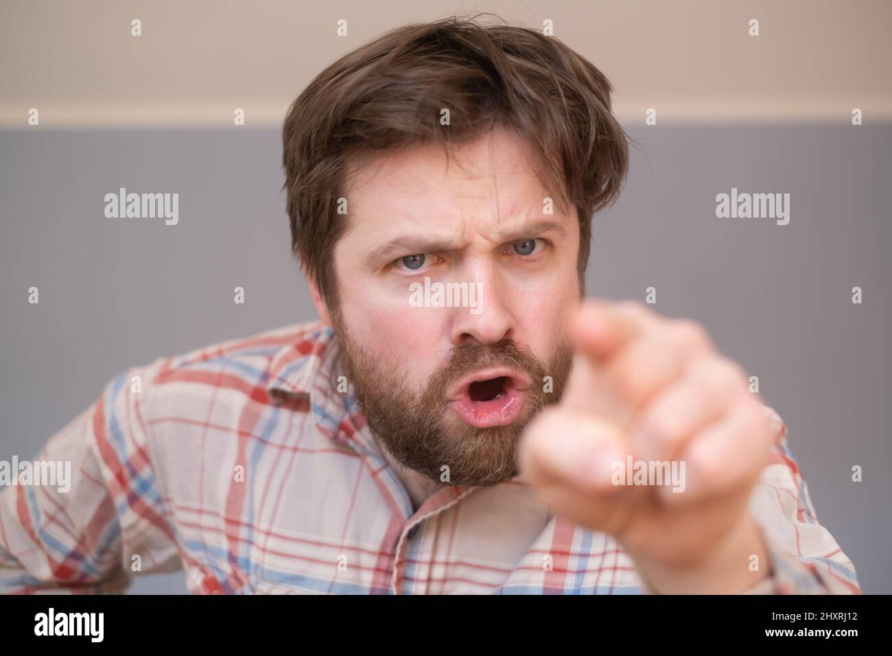 Young handsome man with beard pointing displeased and frustrated to the camera, angry and furious with you Stock Photo