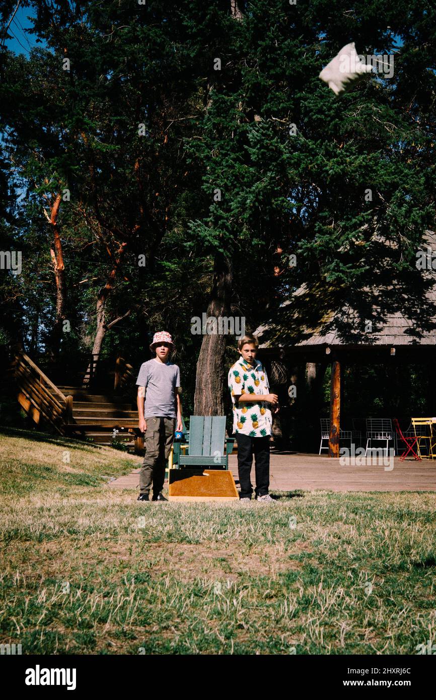 Two Boys Play Corn Hole at a Northwest Resort Stock Photo