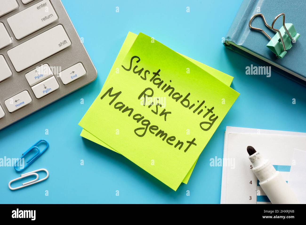 Sustainability risk management sign on the green memo and report. Stock Photo