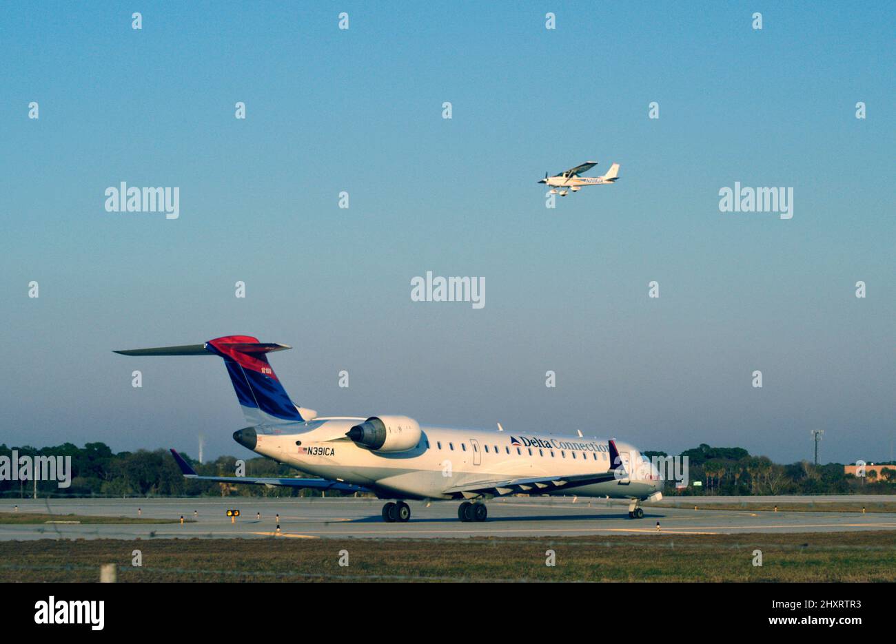 Airplane in the air -- and sharing airport space Stock Photo