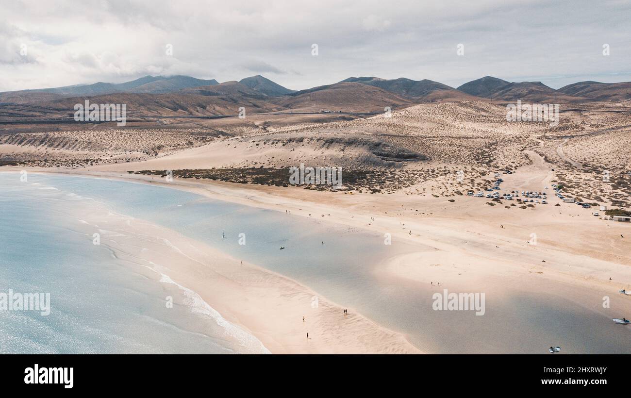 Above view of sand beach and blue ocean and sky with tourists people enjoying travel and summer holiday vacation. Blue sea water. Caribbean landscape Stock Photo