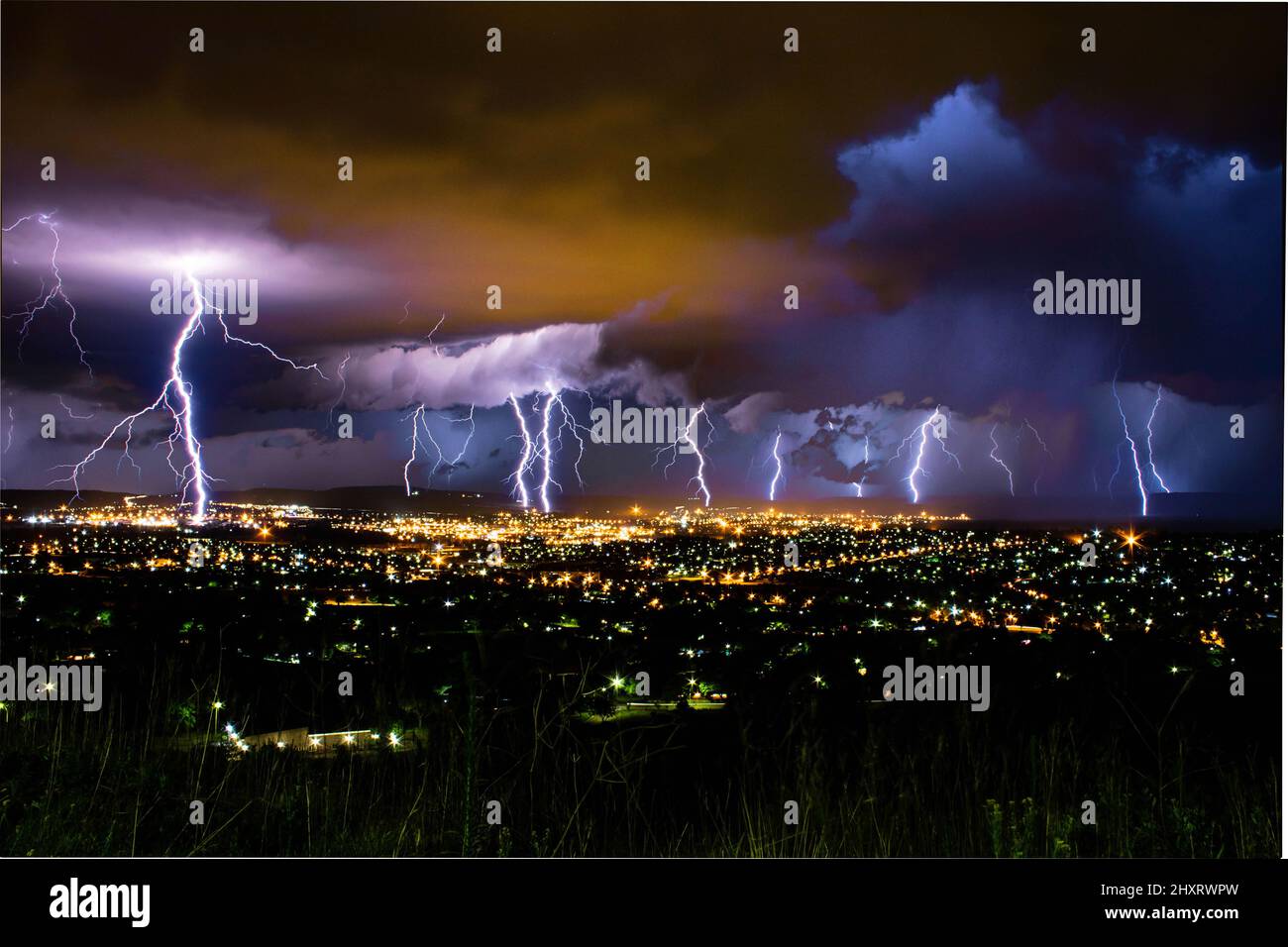 Thunderstorm above a town in night lights Stock Photo Alamy