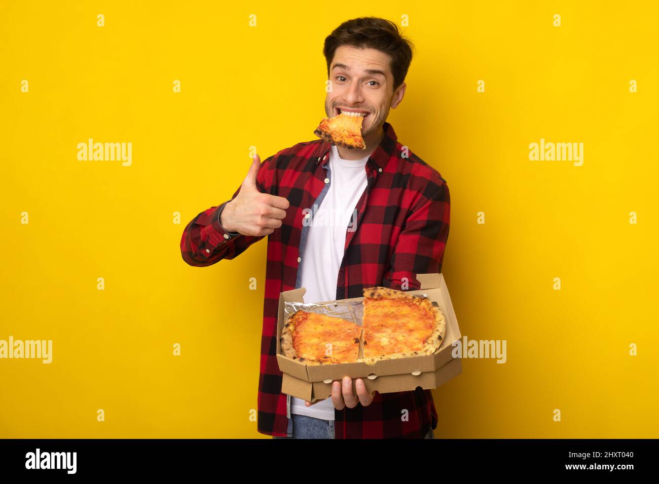 Funny Guy Holding Box Eating Pizza Showing Thumb Up Stock Photo