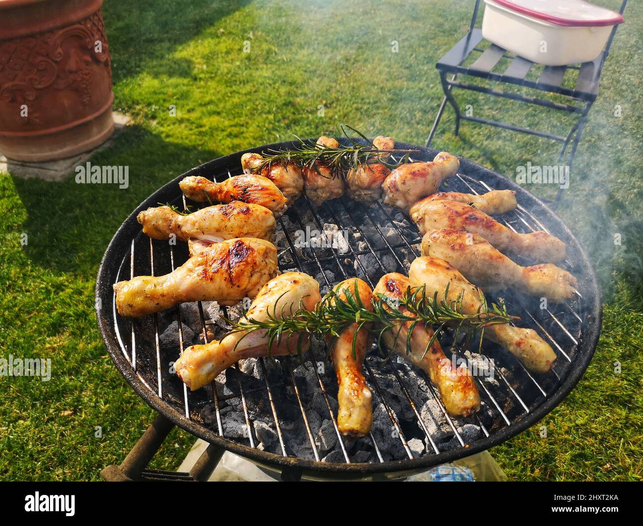 Chicken drumsticks fried with rosemary on a charcoal grill Stock Photo
