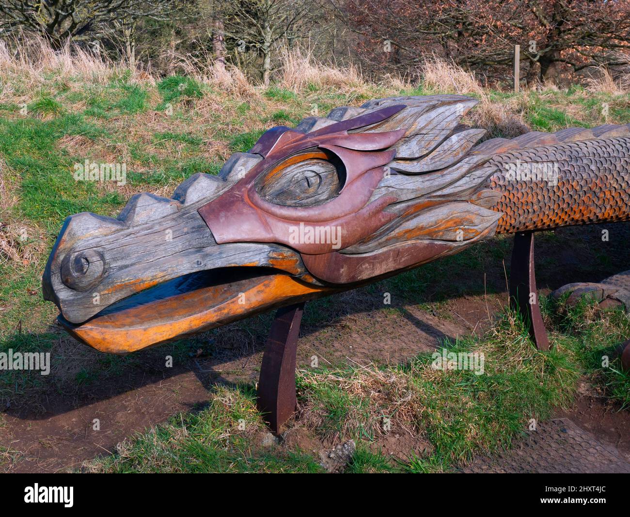 Head detail of a  carved wooden and steel sculpture of a dragon  at North Yorkshire Moors Centre Danby Stock Photo