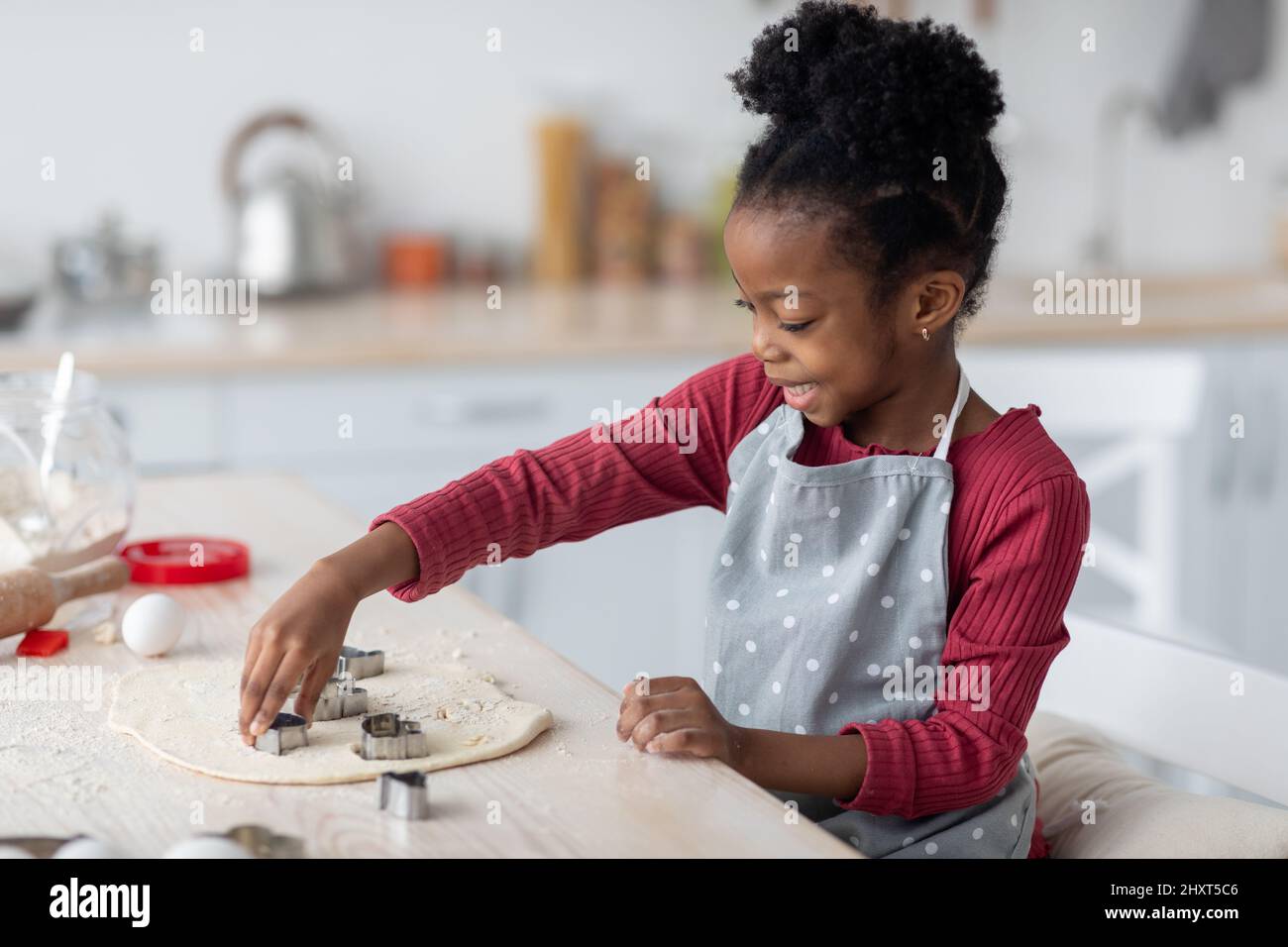 Little cook cute black girl making cookies Stock Photo