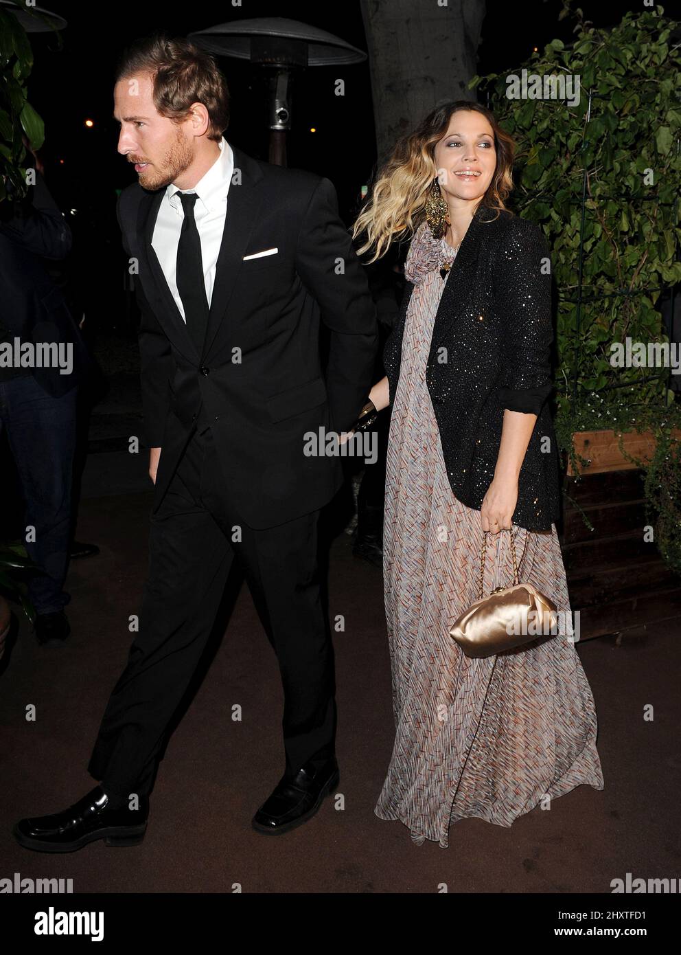 Drew Barrymore and Will Kopelman arrives at the Chanel and Charles Finch Pre-Oscar Dinner at Madeo Restaurant in Los Angeles, California, USA on February 26, 2011. Stock Photo