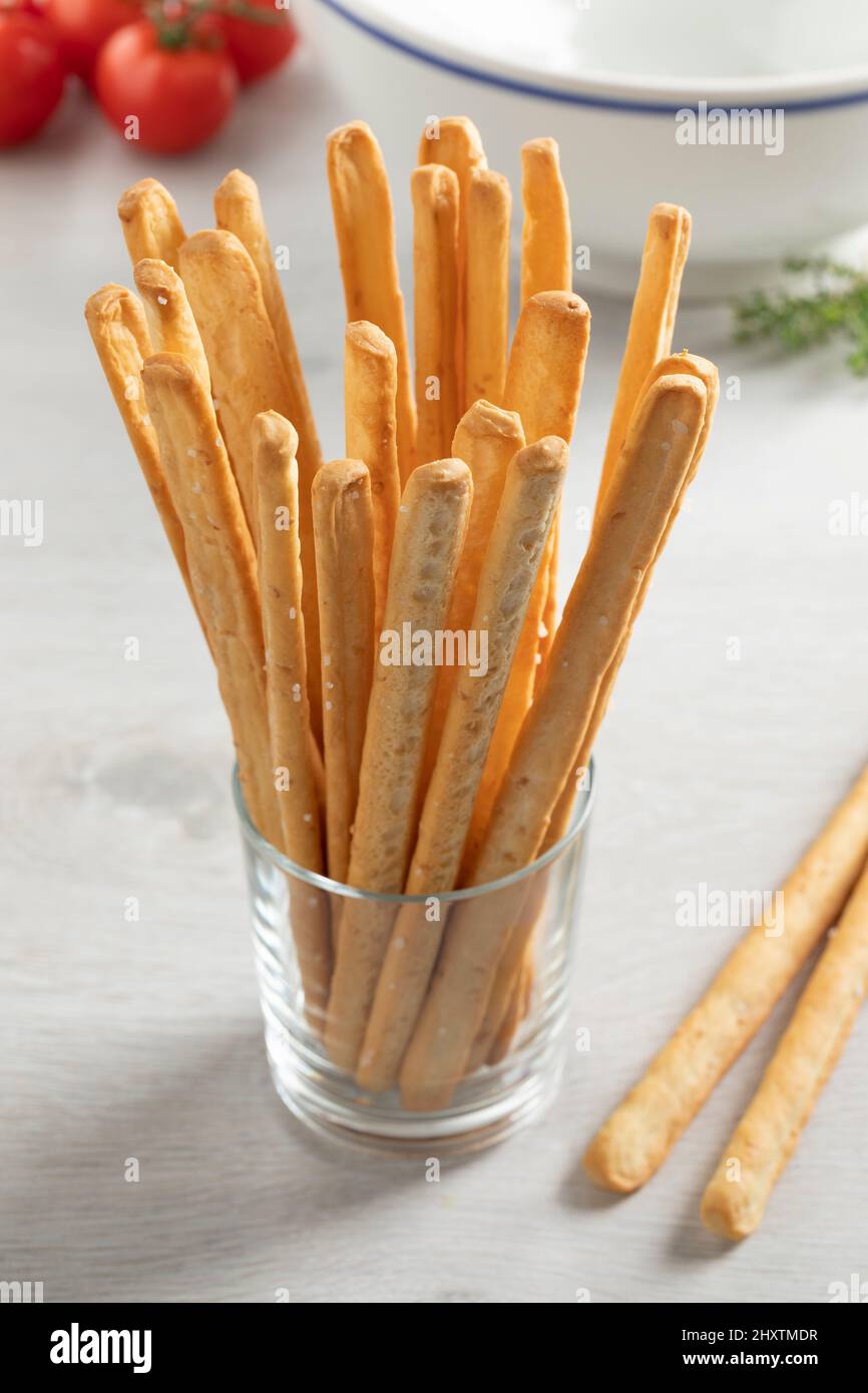 Glass with fresh baked Italian bread sticks as a side dish or snack Stock Photo