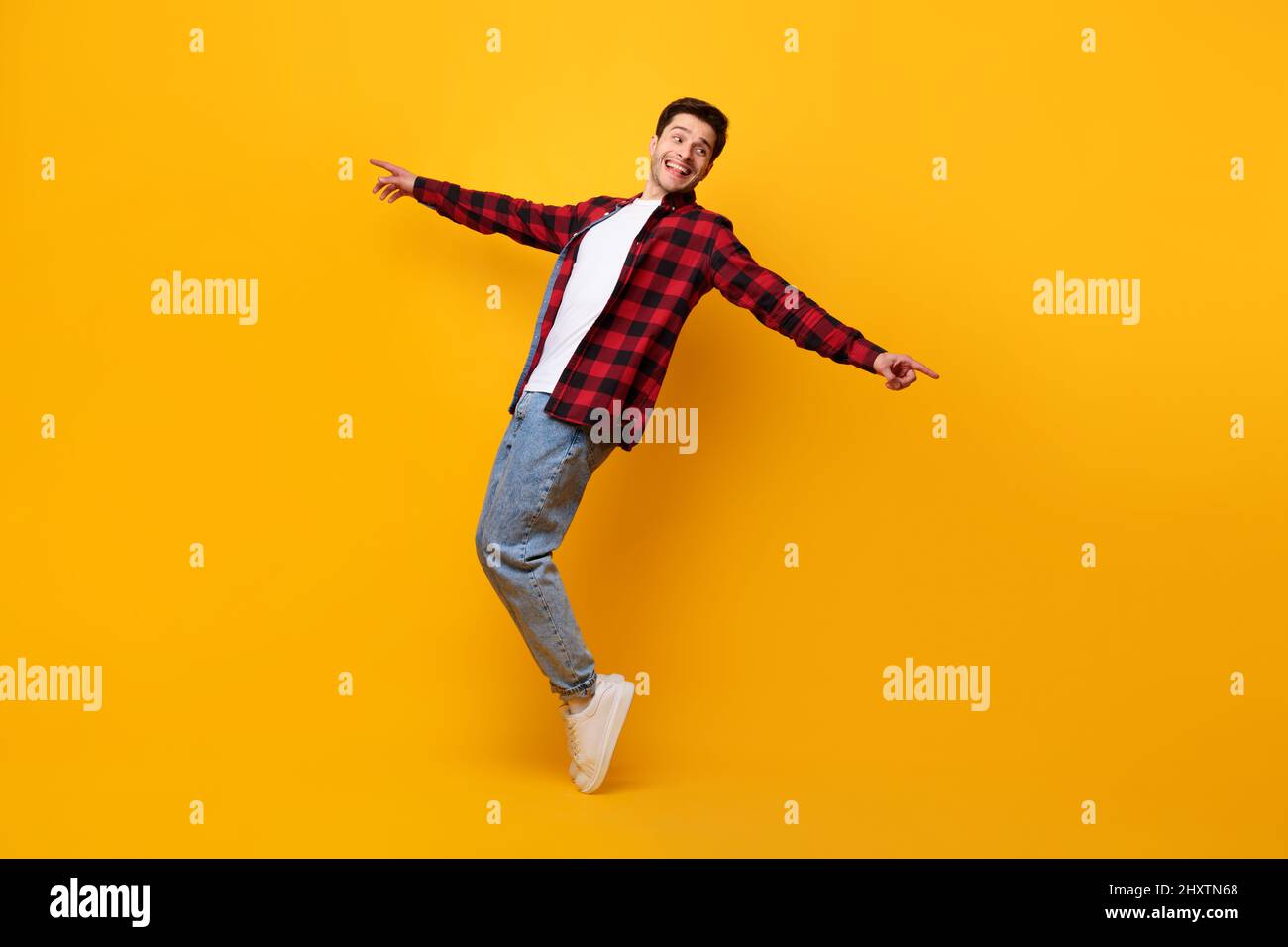 Smiling young man enjoying music dancing disco Stock Photo
