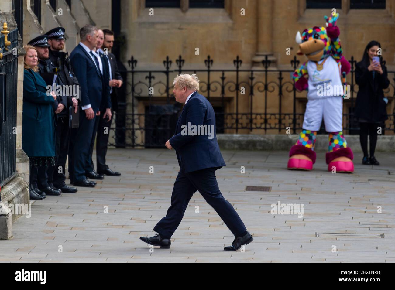 London, UK.  14 March 2022. Perry, the official mascot of the Birmingham 2022 Commonwealth Games, watches Boris Johnson, Prime Minister, arriving at The Commonwealth Service at Westminster Abbey which has been held since 1972 and celebrates the people and cultures of the 54 Commonwealth nations.  The Queen, who recently recovered from Covid-19, did not attend and the Prince of Wales represented her.  Credit: Stephen Chung / Alamy Live News Stock Photo