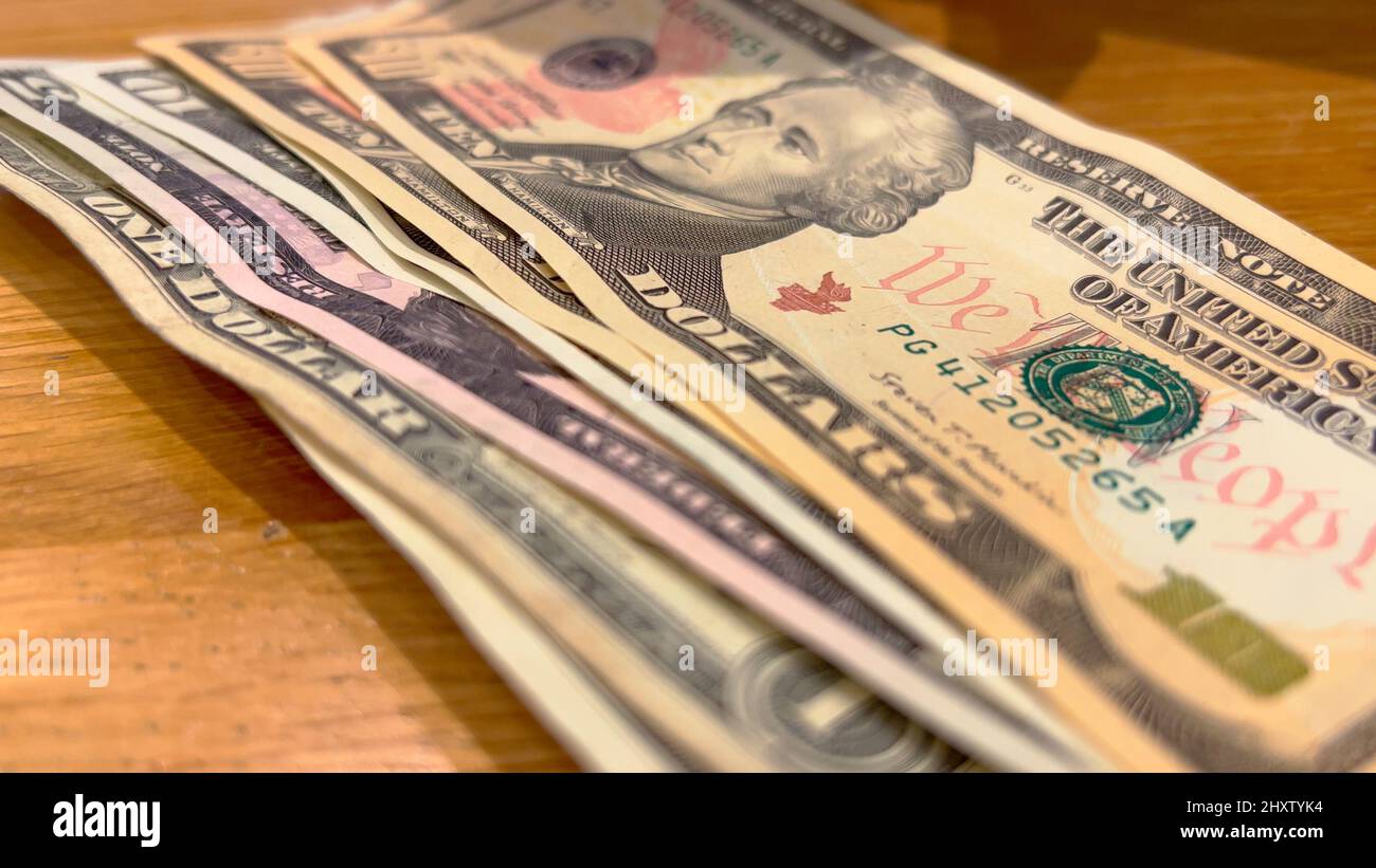 counting-a-bunch-of-dollar-bills-on-a-table-stock-photo-alamy