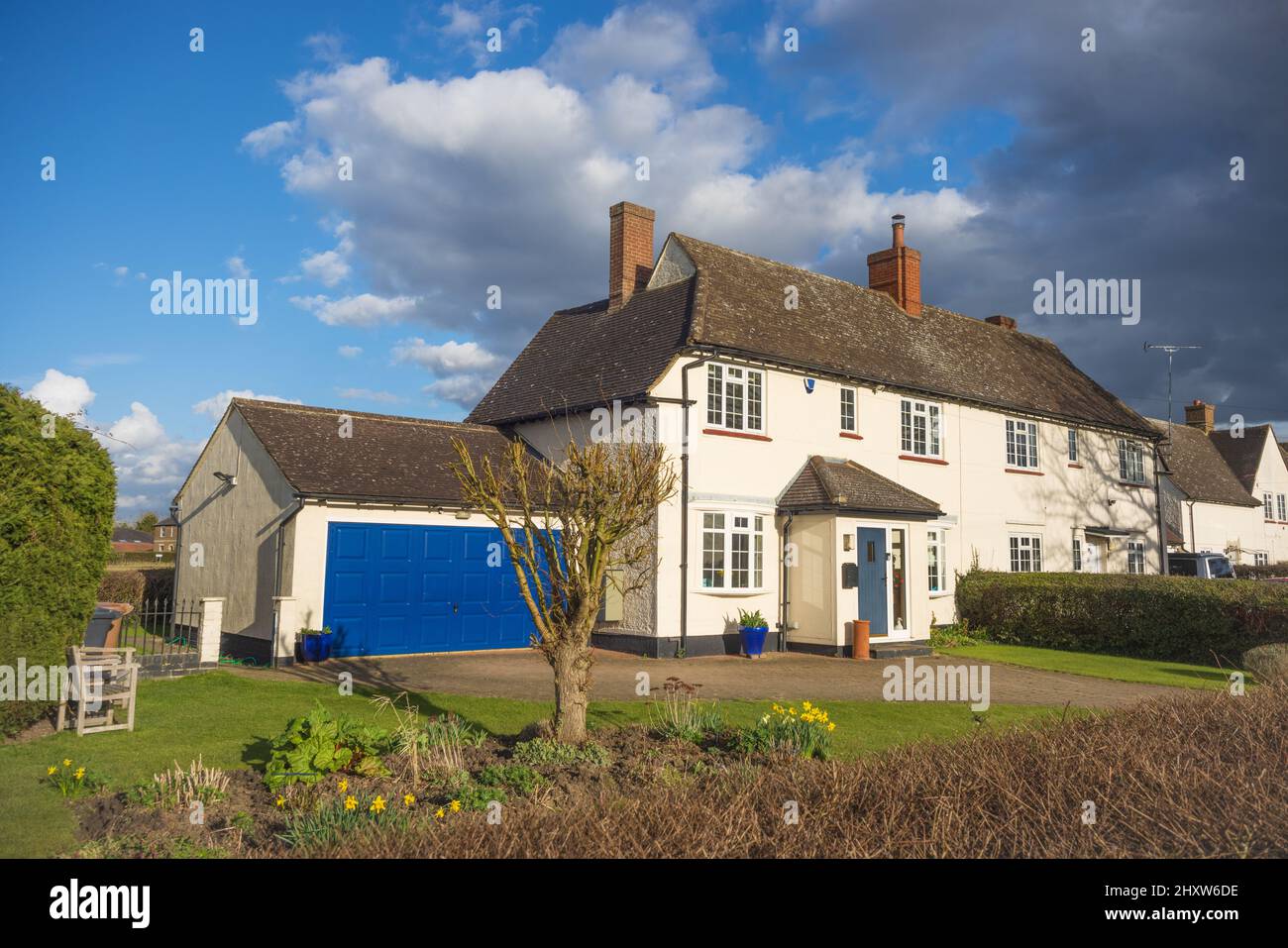 Exterior of a 1920's semi-detached former council house with added porch, double garage and driveway. Hertfordshire. UK Stock Photo