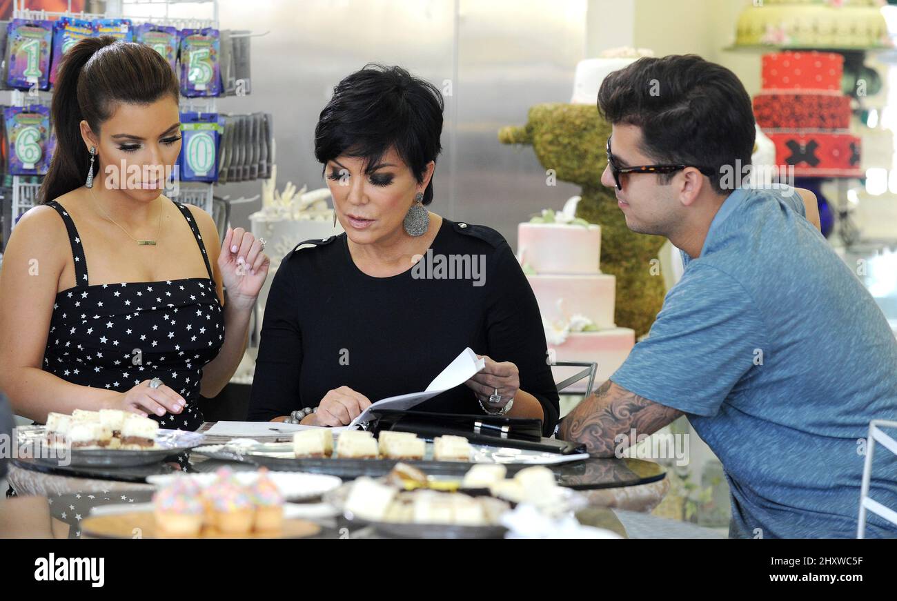 Rob Kardashian, Kris Jenner and Kim Kardashian are seen wedding cake
