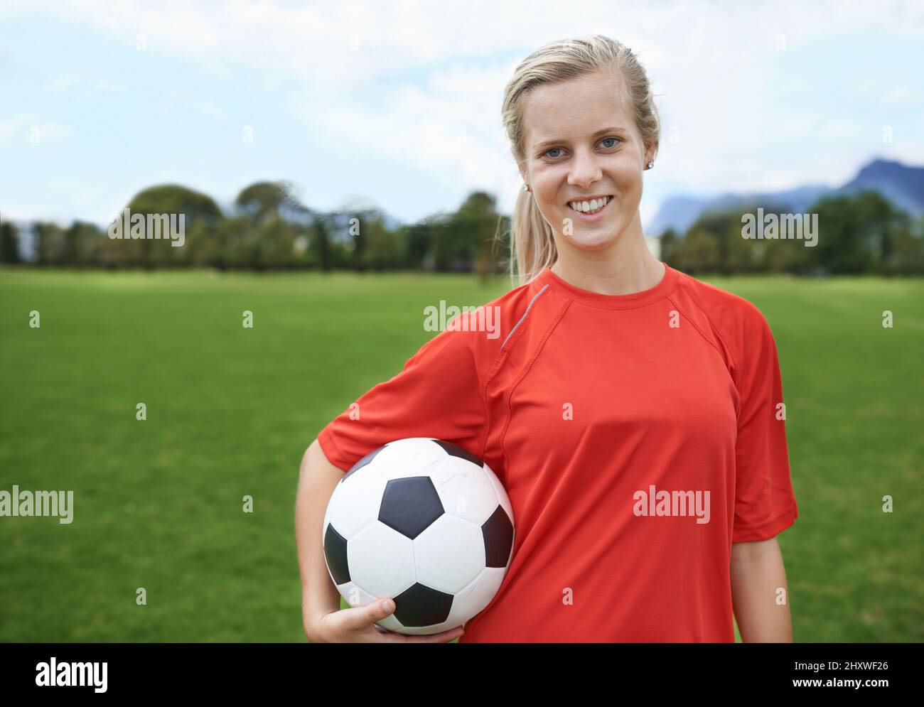 In it to win. Shot of a young female soccer player holding a soccer