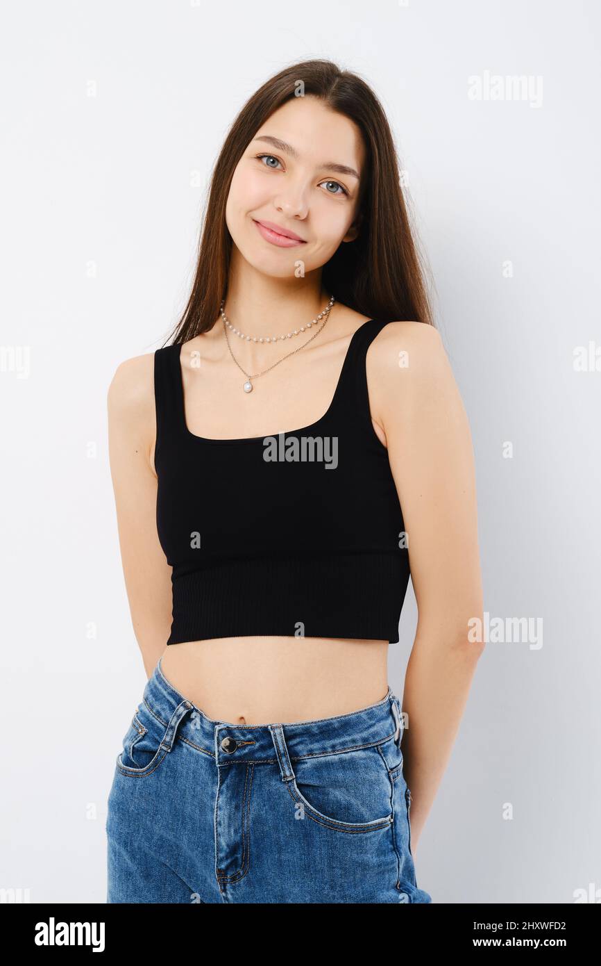 Studio portrait of shy and cute young woman over white background with