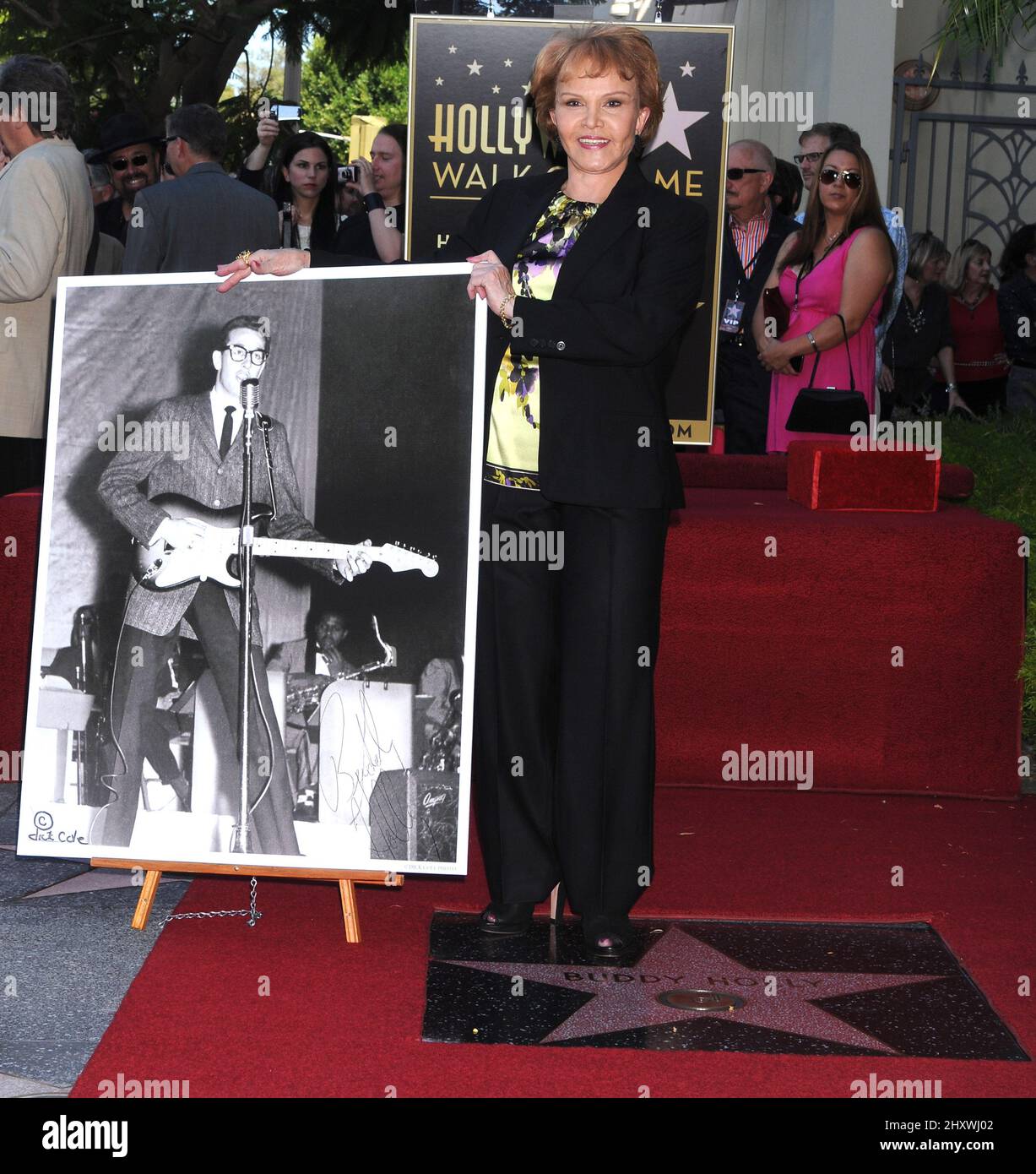 Maria Elena Holly poses as Buddy Holly is honored on the Hollywood Walk of Fame in front of the Capital Records Building, Hollywood, California on September 07, 2011. Stock Photo
