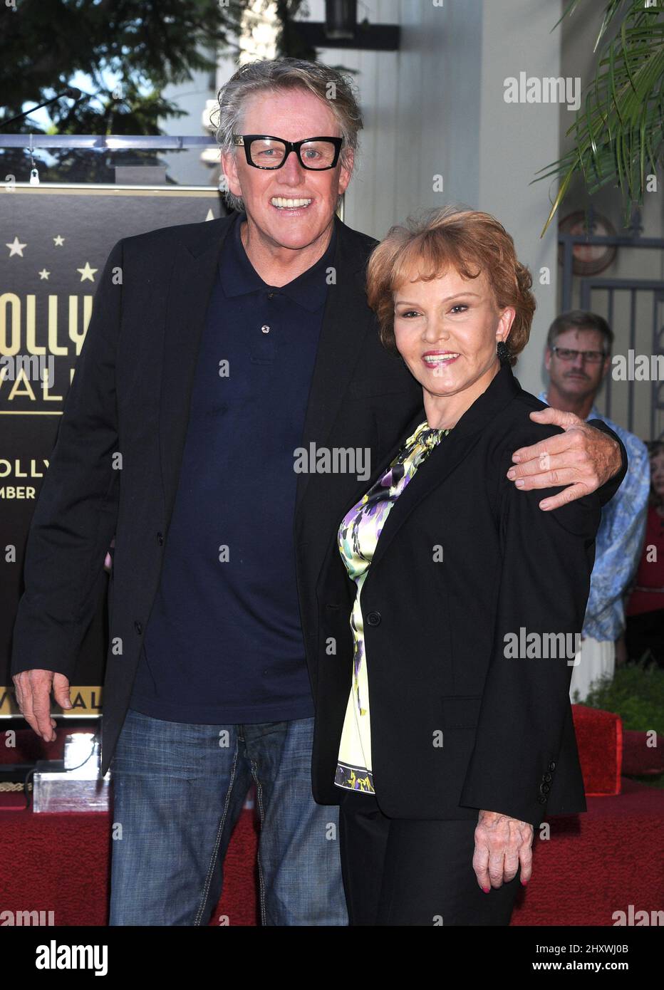 Gary Busey and Maria Elena Holly pose as Buddy Holly is honored on the Hollywood Walk of Fame in front of the Capital Records Building, Hollywood, California on September 07, 2011. Stock Photo