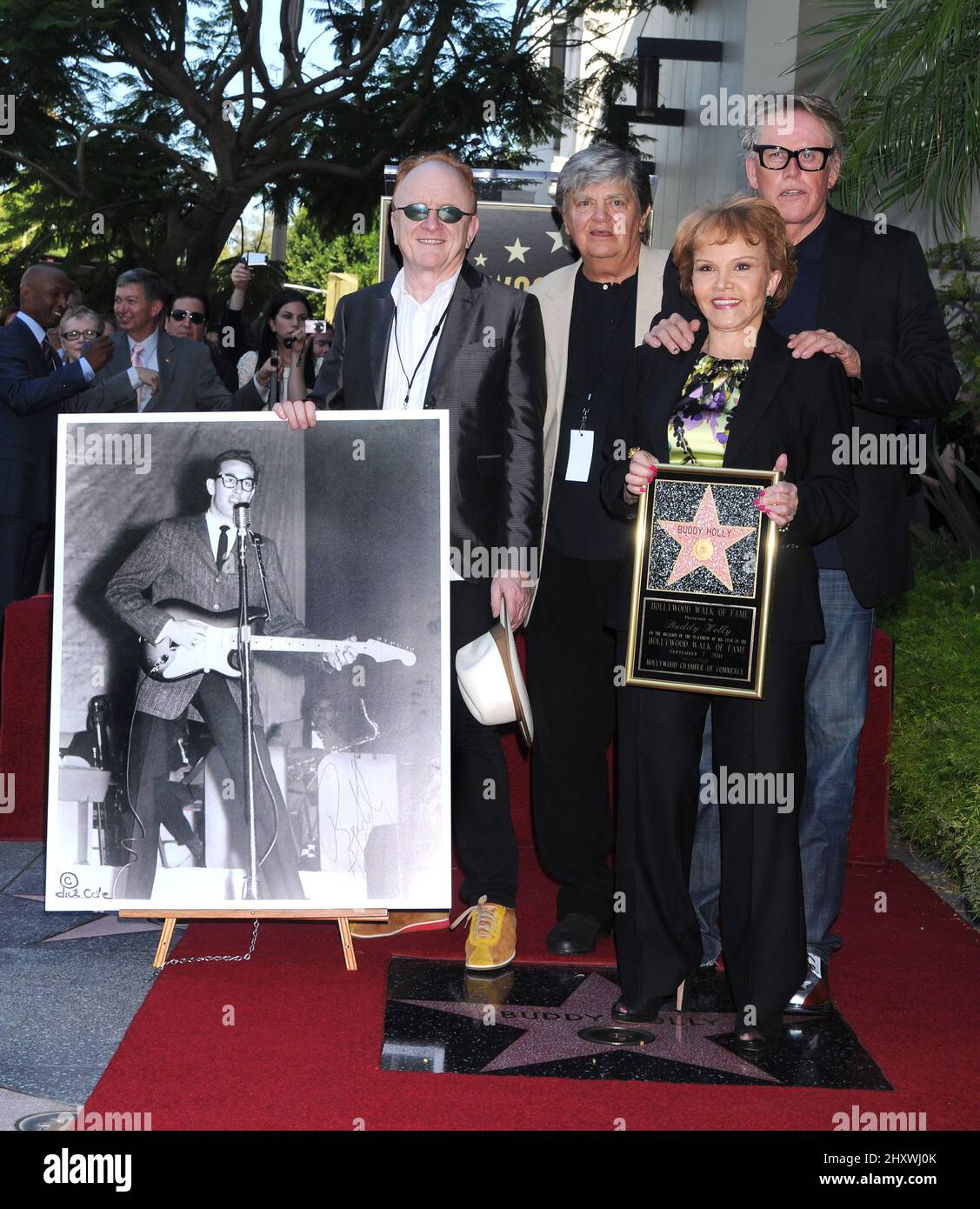 Peter Asher, Phil Everly, Maria Elena Holly and Gary Busey pose as Buddy Holly is honored on the Hollywood Walk of Fame in front of the Capital Records Building, Hollywood, California on September 07, 2011. Stock Photo