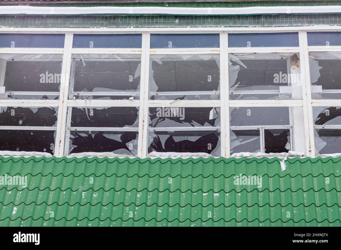 Many broken windows on the brick wall of the building after the ...