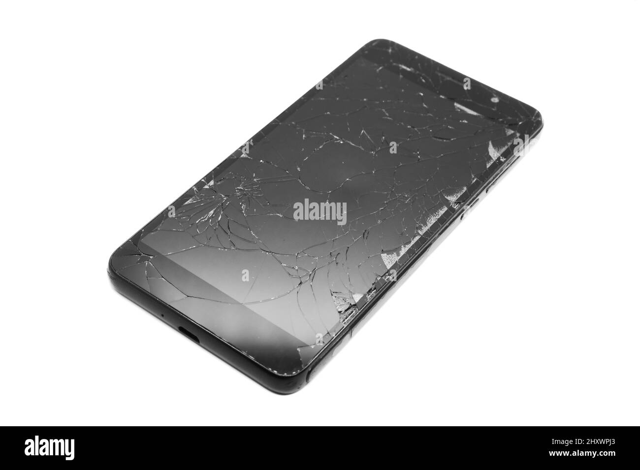 Broken display on a black smartphone isolate on a white background. Smartphone repair. Smartphone display replacement. Stock Photo