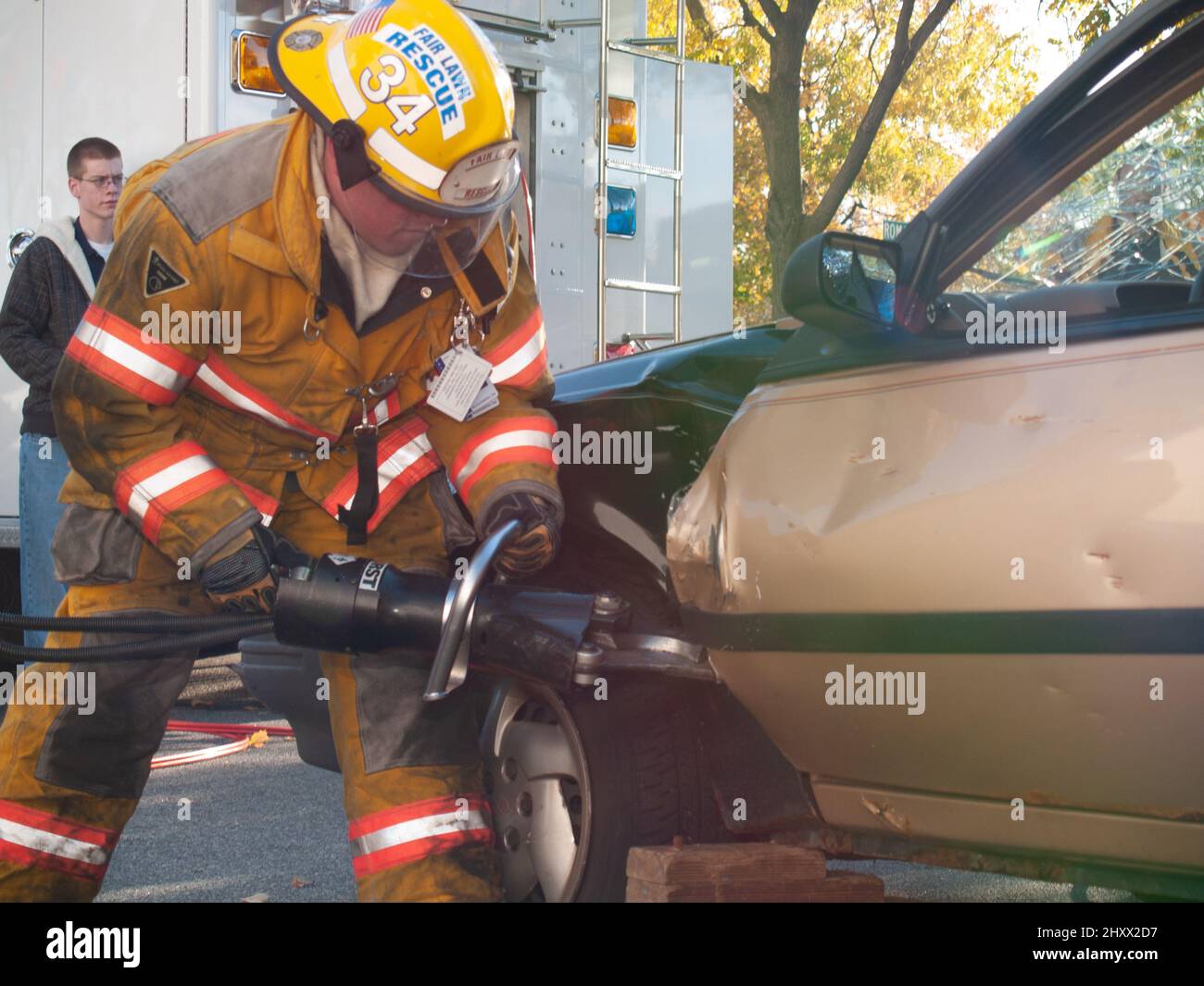 Rescue worker with wrecked car during drill Stock Photo - Alamy