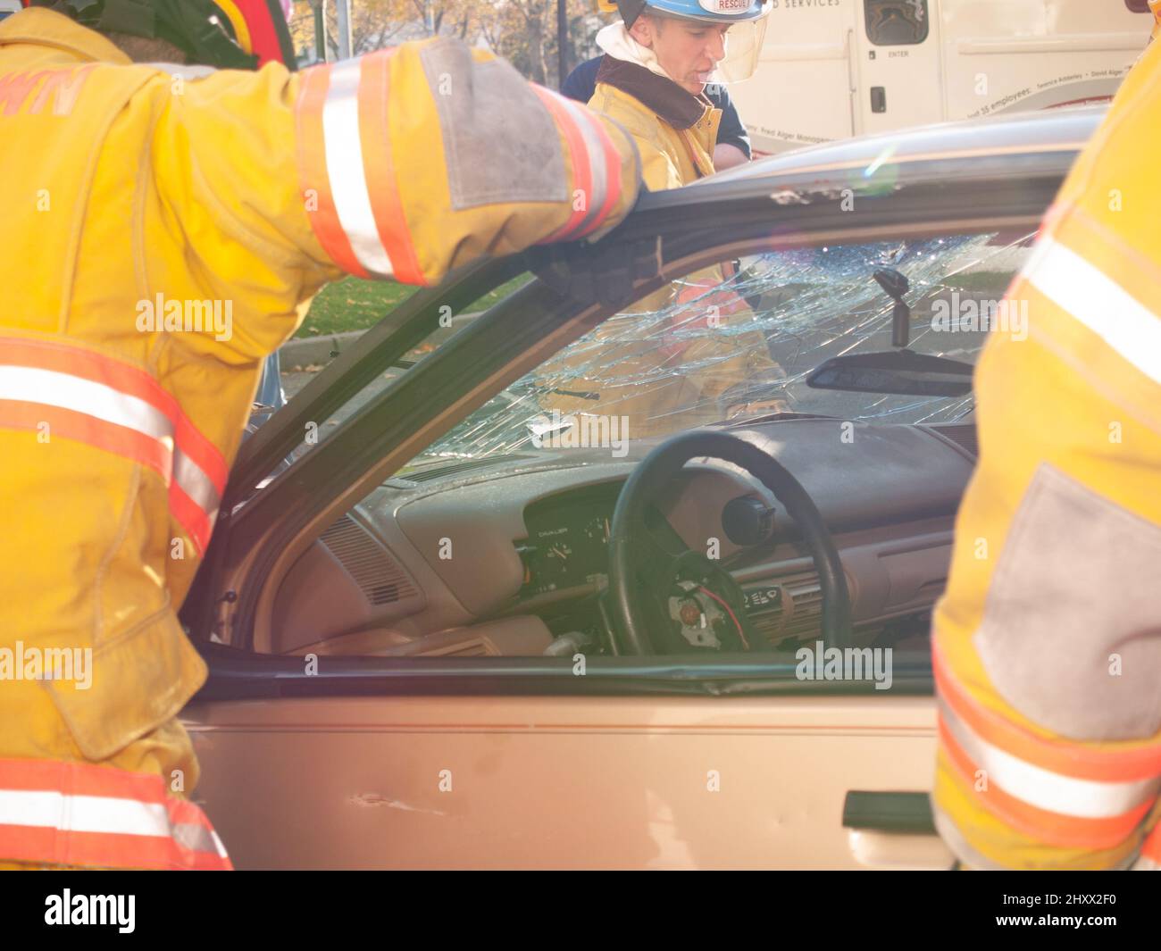 Rescue worker with wrecked car during drill Stock Photo