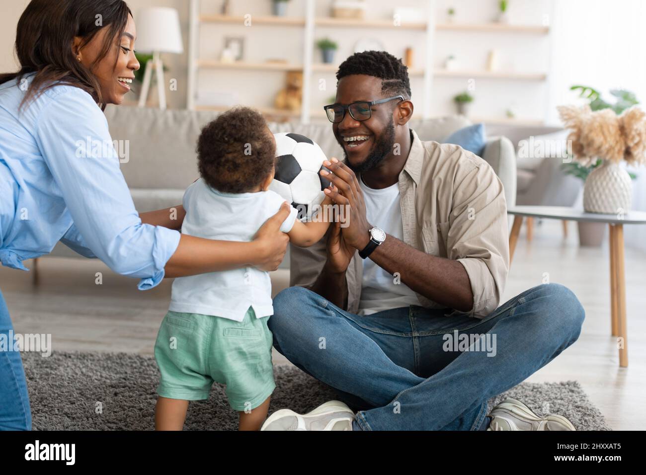 Portrait of happy black family smiling playing at home Stock Photo - Alamy