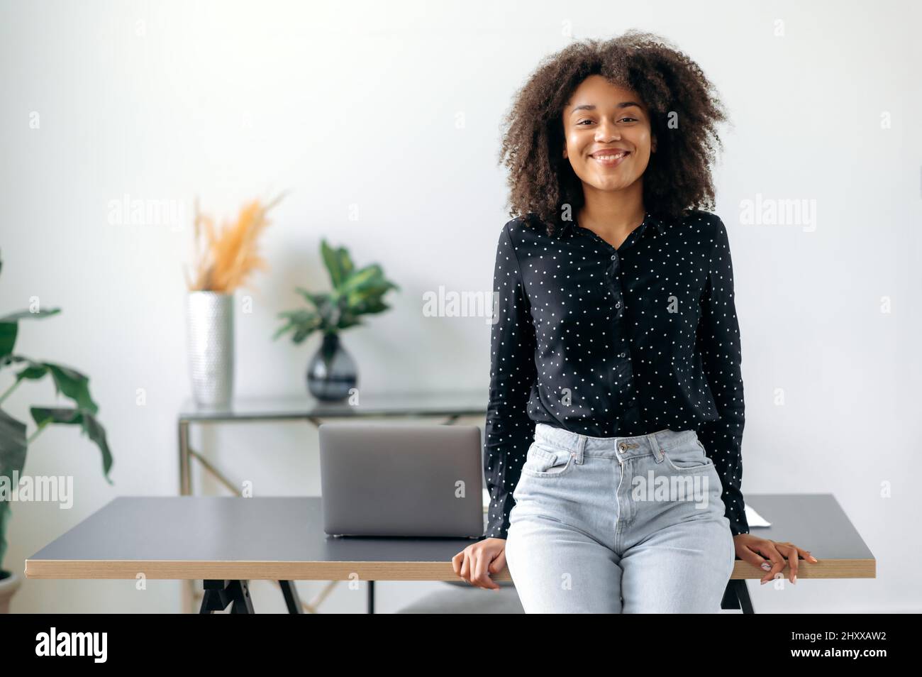 Successful happy pretty young darkskinned girl, business woman, broker