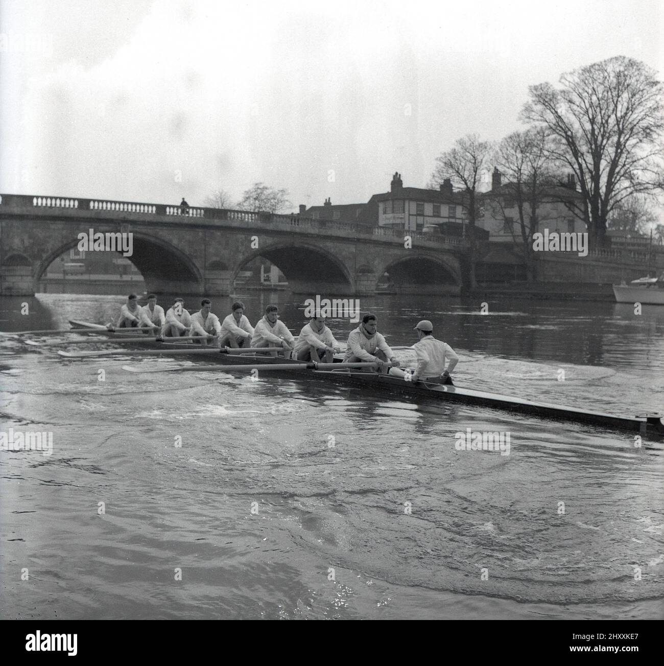1961, historical, the crew of Cambridge University Boat club on the river Thames at Henley-in-Thames, Berkshire, England, UK, in training for the upcoming Oxford and Cambridge Boat Race, England, UK. This famous university rowing race, began in 1829, is a annual event on theThames over the championship course between Putney and Barnes in South West London. Stock Photo