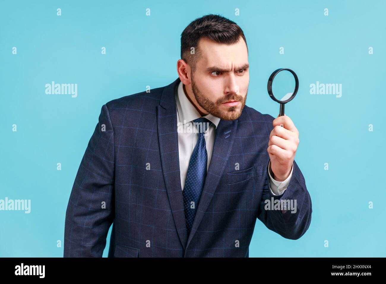 Businessman looking at camera through a magnifying glass - CareerZot