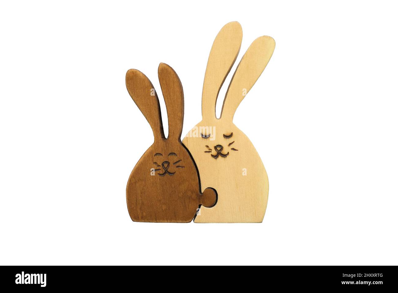 Wooden figures of two hares together isolated on white background. Concept of family and love, mother and child. Stock Photo