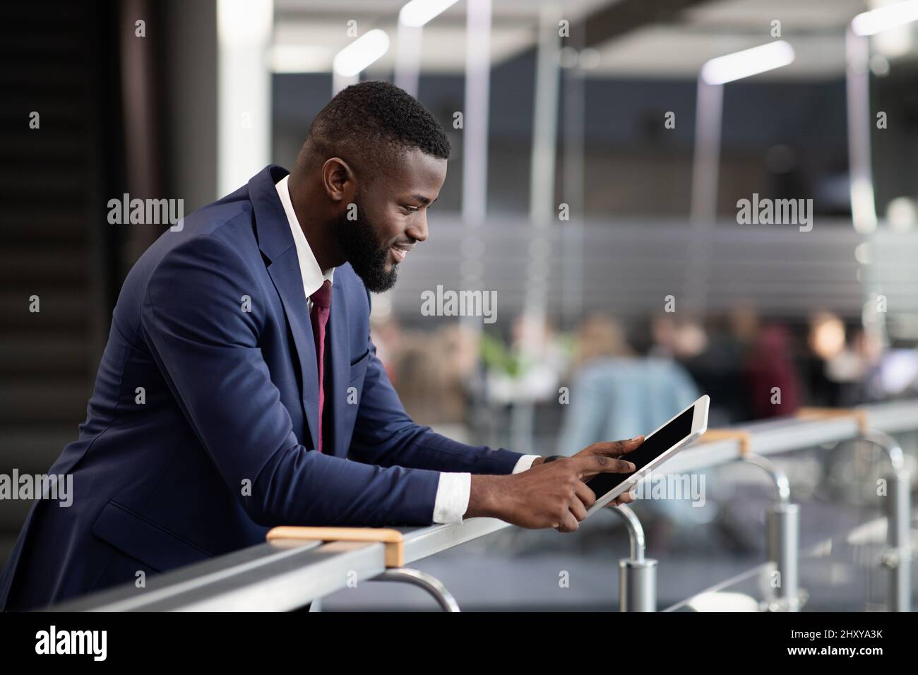 Smiling african american businessman using digital tablet Stock Photo