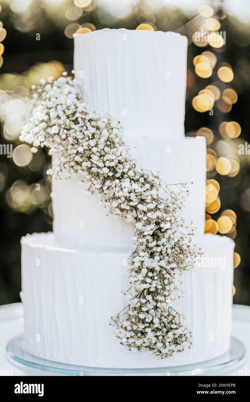 Beautiful white wedding cake with flowers Stock Photo - Alamy