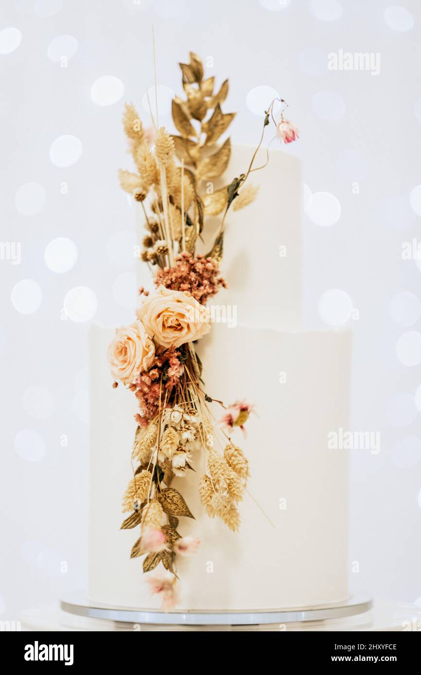 Beautiful white wedding cake with flowers Stock Photo - Alamy