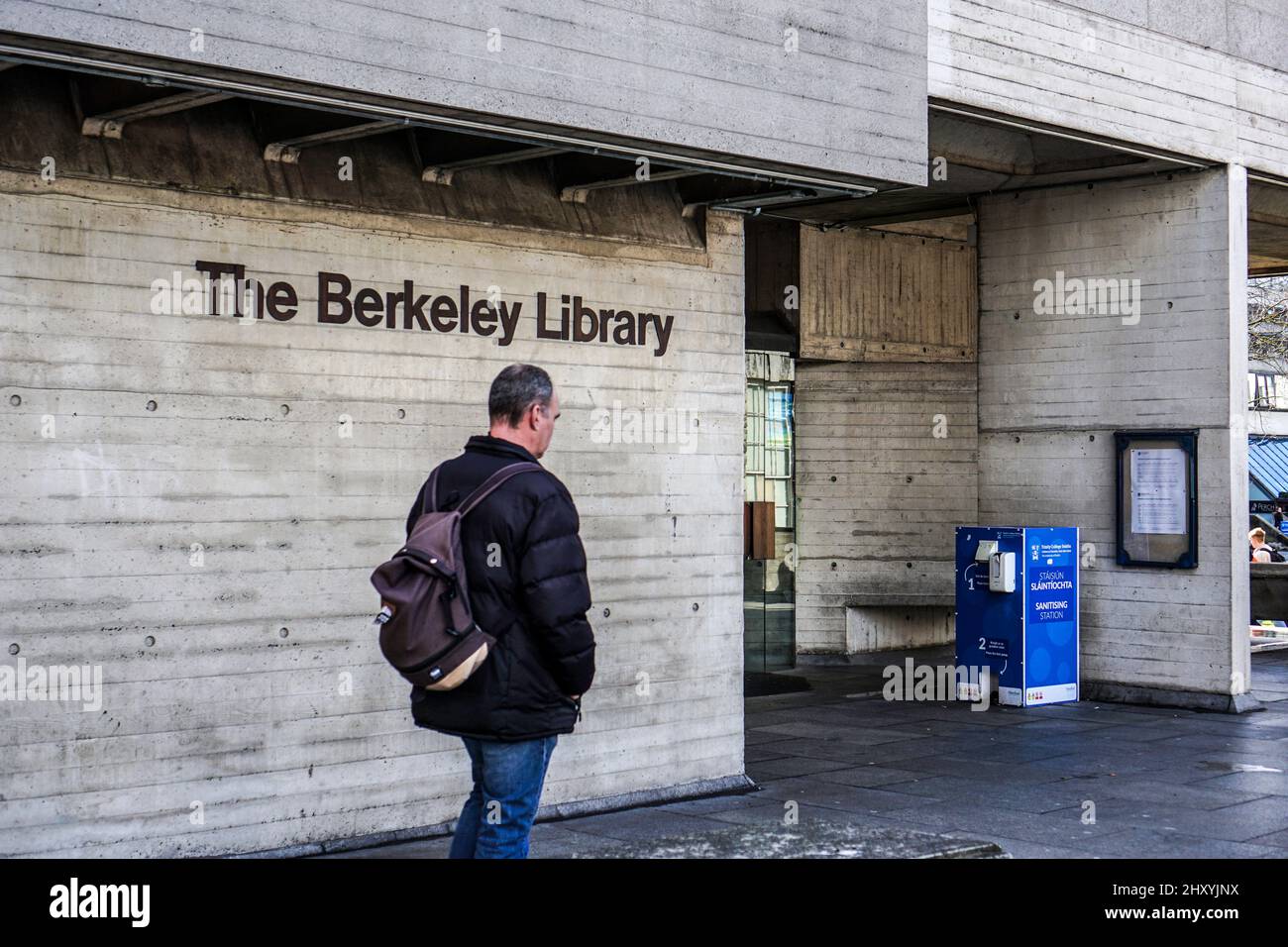 A man passing the Berkeley Library in Trinity College, Dublin, Ireland. Stock Photo