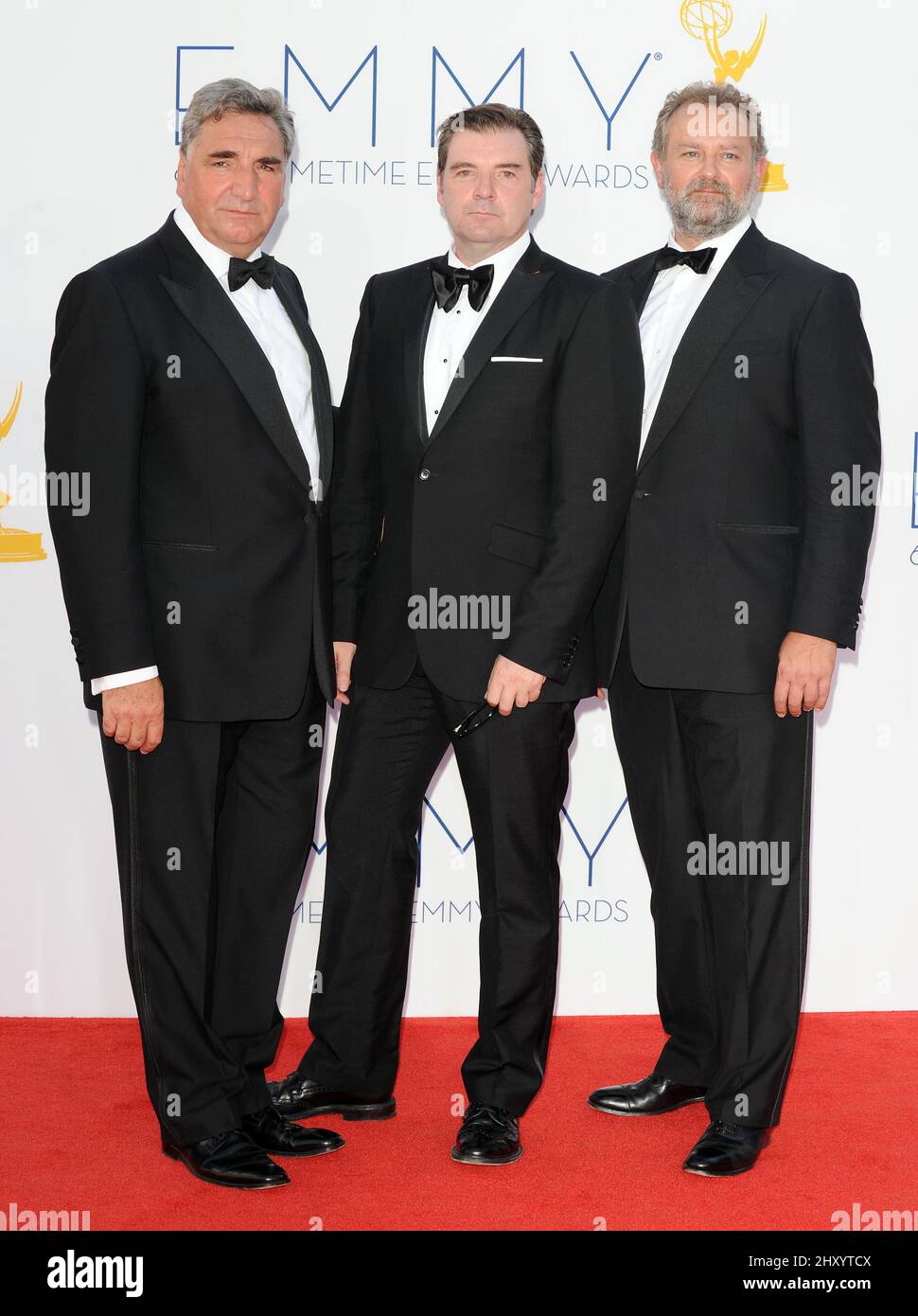 Jim Carter, Hugh Bonneville and Brendan Coyle attends the 64th Primetime Emmy Awards held at the Nokia Theatre, Los Angeles. Stock Photo