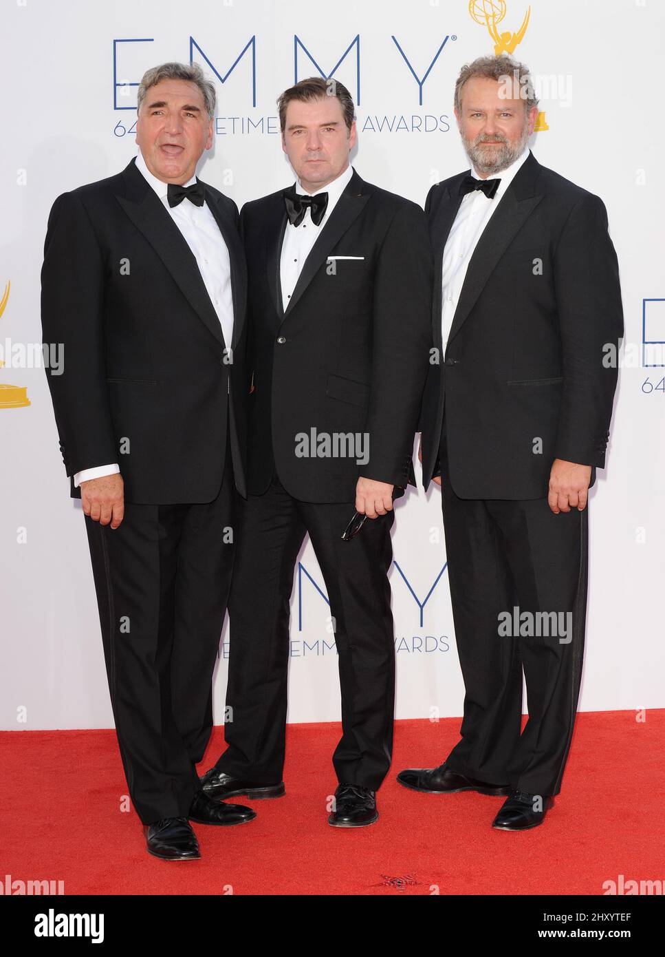 Jim Carter, Hugh Bonneville and Brendan Coyle attends the 64th Primetime Emmy Awards held at the Nokia Theatre, Los Angeles. Stock Photo