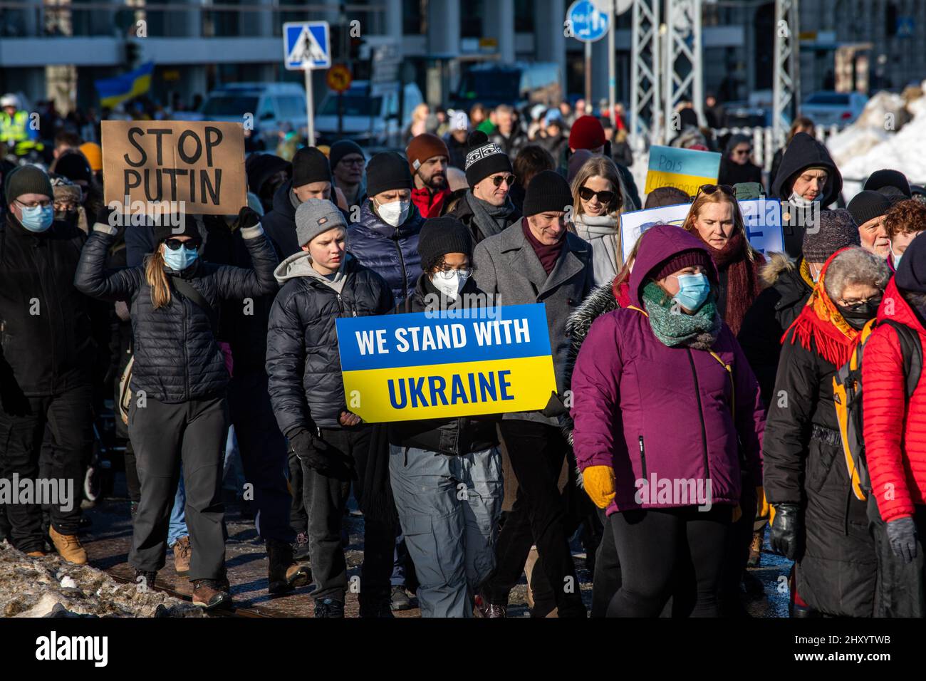 We stand with Ukraine. Woman holding a sign or placard at protest against invasion of Ukraine in Helsinki, Finland. Stock Photo